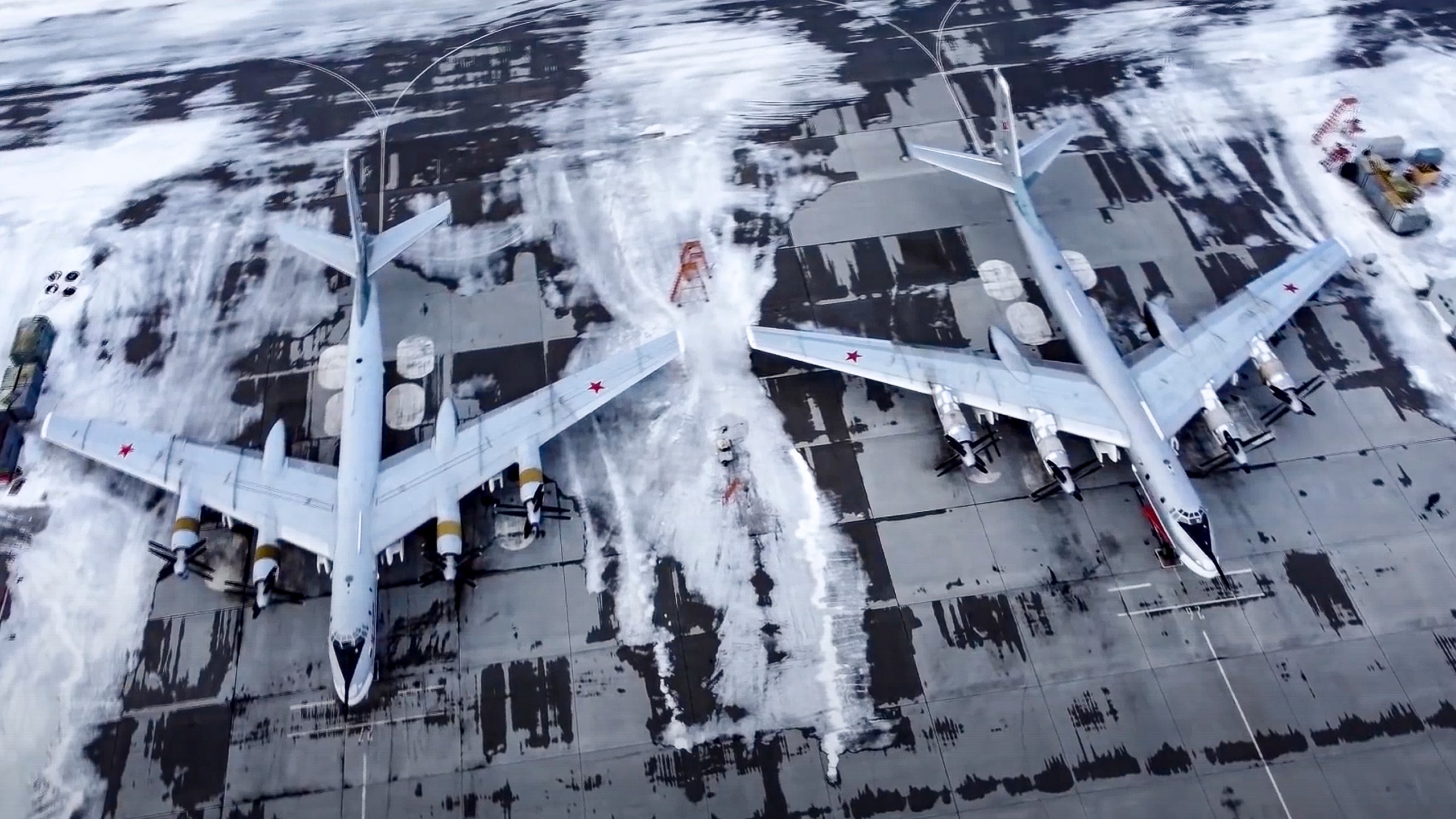 In this image taken from video provided by the Russian Defense Ministry Press Service, a pair of Tu-95 strategic bombers of the Russian air force are parked at an air base in Engels near the Volga River in Russia on Jan. 24, 2022.(Russian Defense Ministry Press Service via AP)