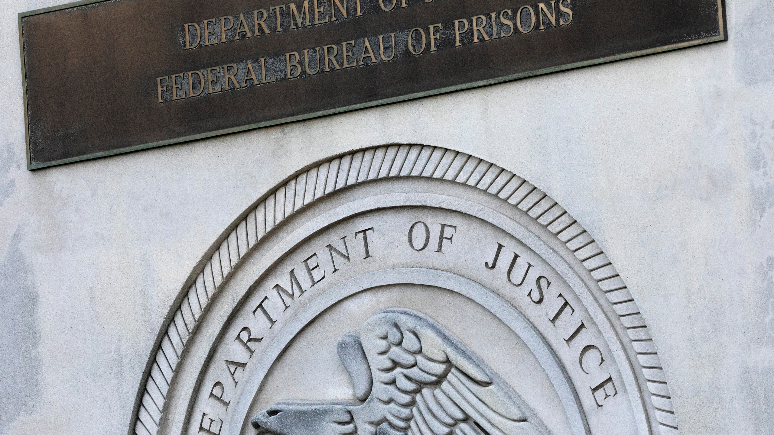 In this July 6, 2020, photo, a sign for the Department of Justice Federal Bureau of Prisons is displayed at the Metropolitan Detention Center in New York. (AP Photo/Mark Lennihan, File)