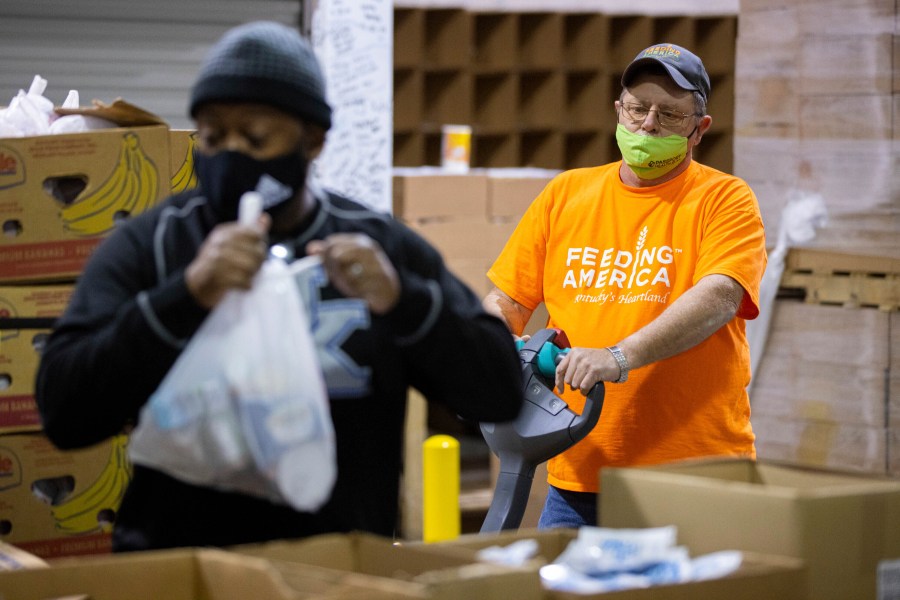 Warehouse manager Marty Highbaugh moves a pallet of prepared food bags for the backpack at Feeding America food bank in Elizabethtown, Ky., Monday, Jan. 17, 2022. Food banks across the country are experiencing a critical shortage of volunteers as the omicron variant frightens people away from group activities. (AP Photo/Michael Clubb)