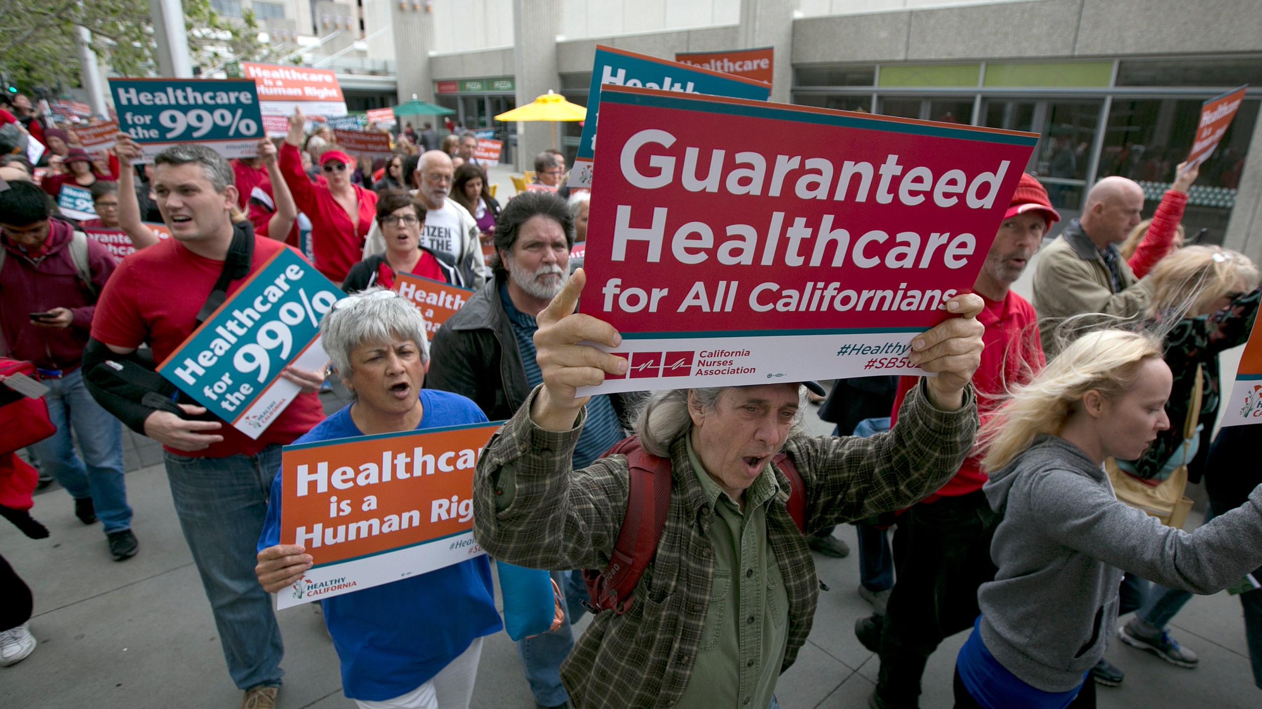 Supporters of single-payer health care march to the Capitol, Wednesday, April 26, 2017, in Sacramento, Calif. On Monday, Jan. 31, 2022, California Democrats face a deadline to advance a bill that would create a government-funded universal health care system. The proposal has the support of some Democratic leaders and powerful labor union, but it faces strong opposition from business groups who say it would cost too much. (AP Photo/Rich Pedroncelli, File)