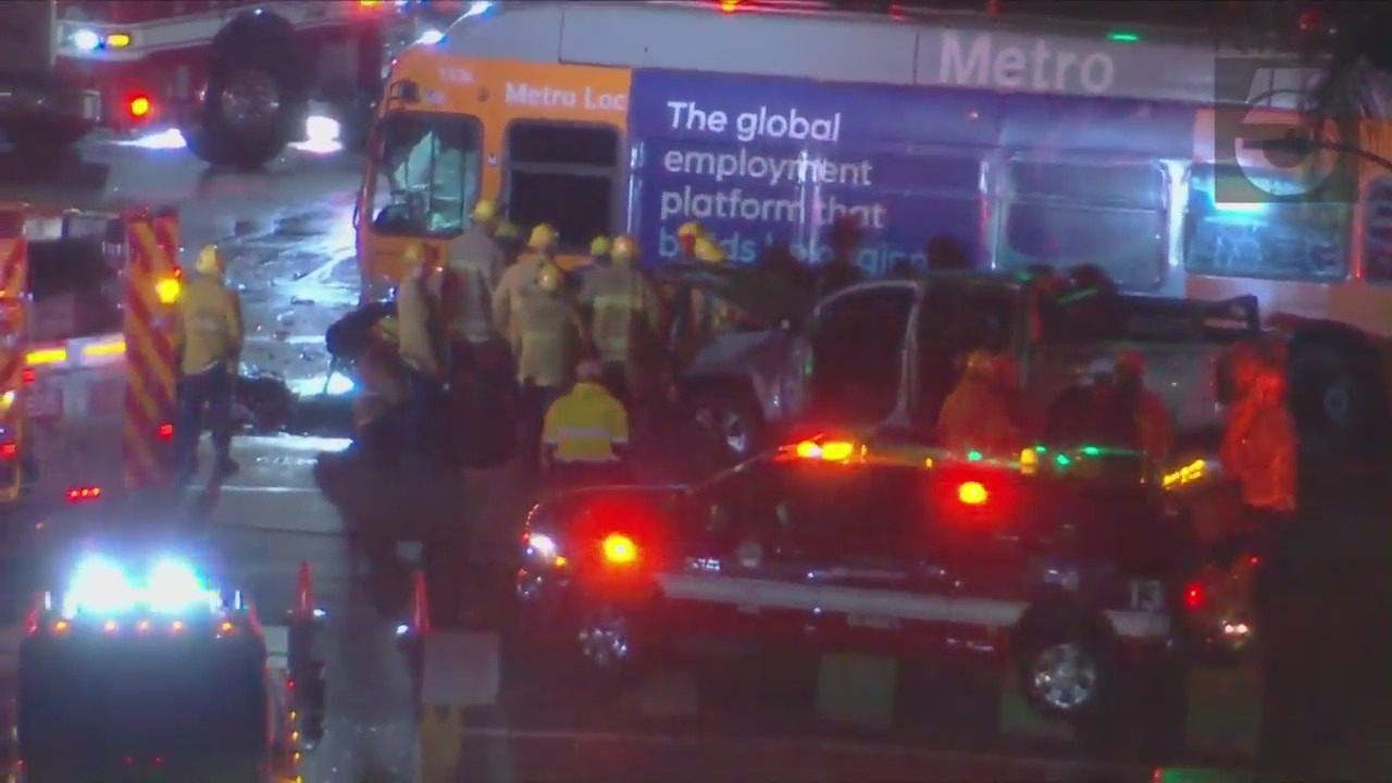 Multiple LAFD units responded after a bus collided with a car, which then caught fire, in Manchester Square on Jan. 28, 2022. (KTLA)