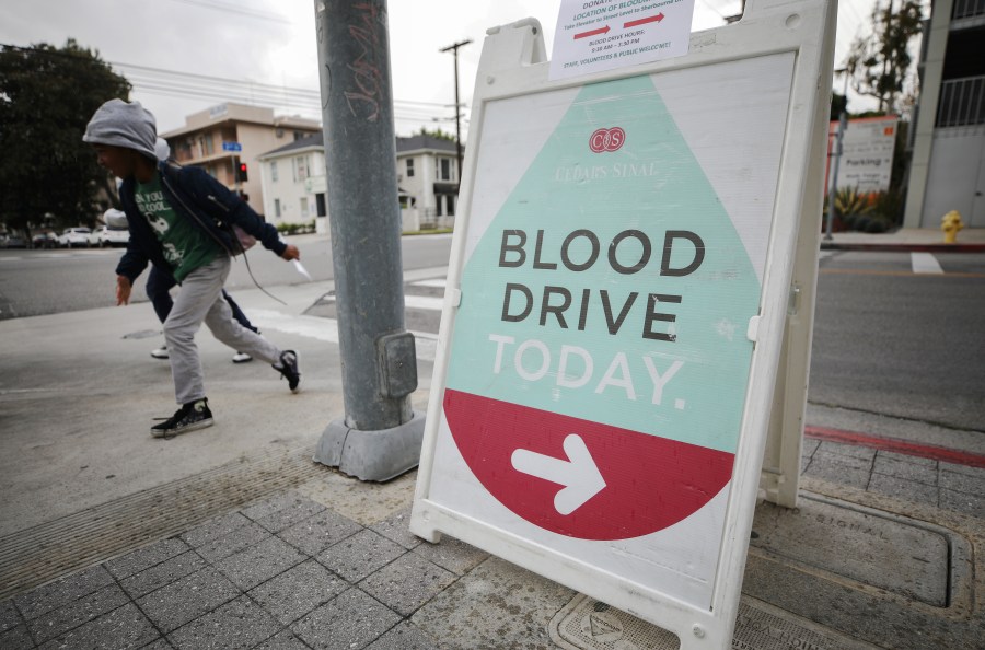 A sign advertises a blood drive being held in a blood mobile outside Cedars-Sinai Medical Center on March 19, 2020 in Los Angeles, California. (Photo by Mario Tama/Getty Images)