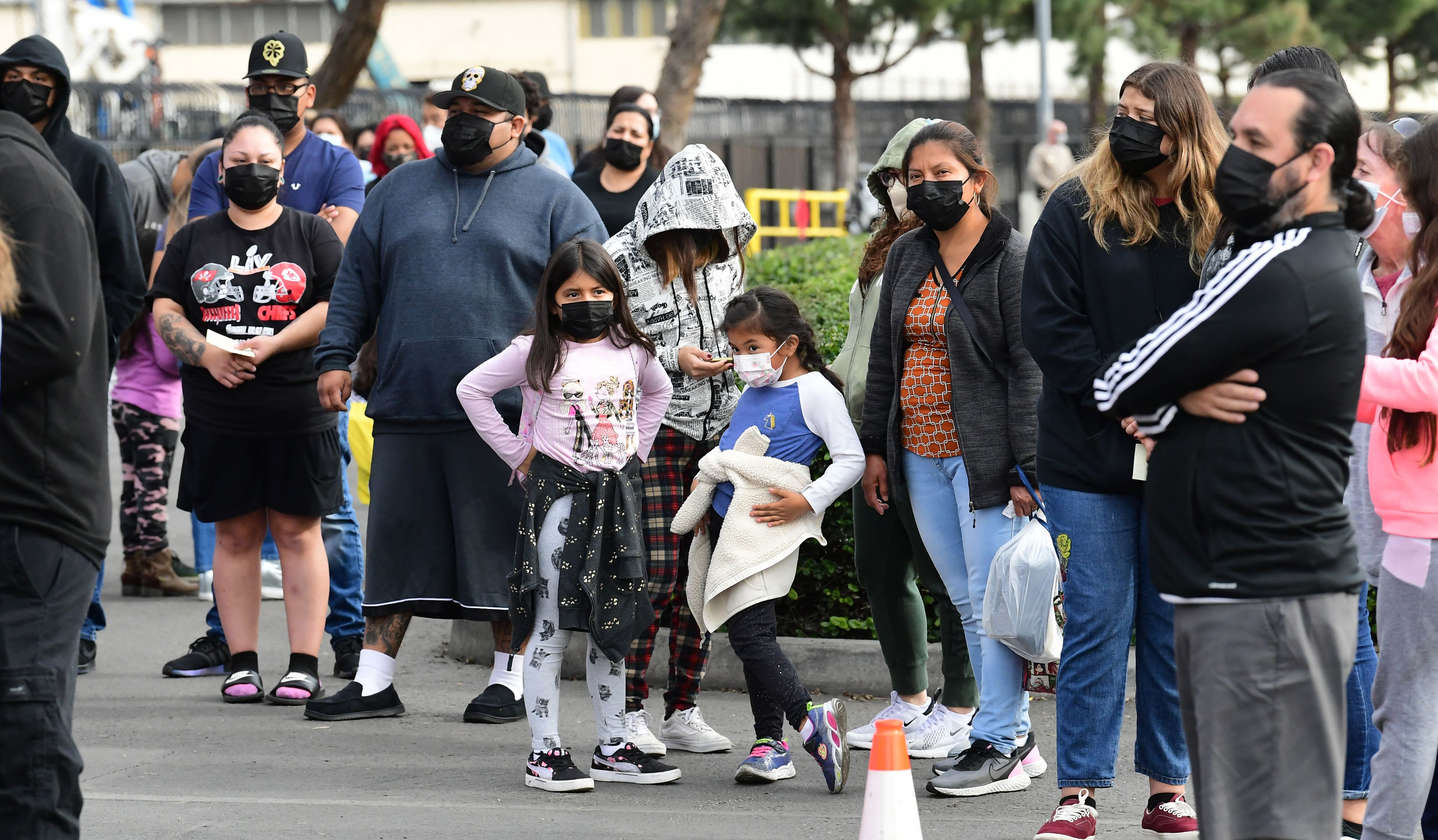 People wait in line for a test at a BusTest Express mobile COVID-19 test site in Paramount, a city in Los Angeles County, California, on Jan. 12, 2022. (FREDERIC J. BROWN/AFP via Getty Images)