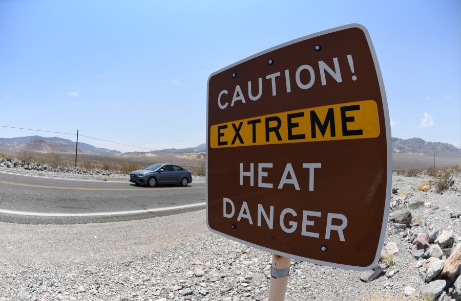 A warning sign posted alerts visitors of heat dangers on July 11, 2021 in Death Valley National Park, California. (David Becker/Getty Images)