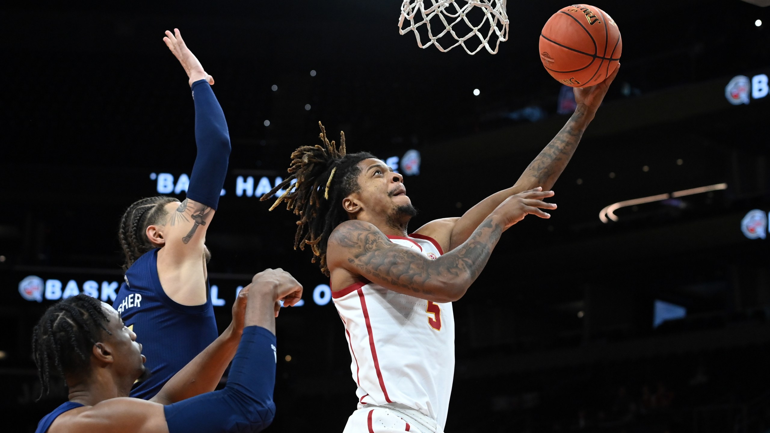 Isaiah White #5 of the University of Southern California Trojans scores on a lay up while being defended by Jordan Usher #4 of the Georgia Tech Yellow Jackets during the second half at the Jerry Colangelo Classic at Footprint Center on Dec. 18, 2021 in Phoenix. (Norm Hall/Getty Images)