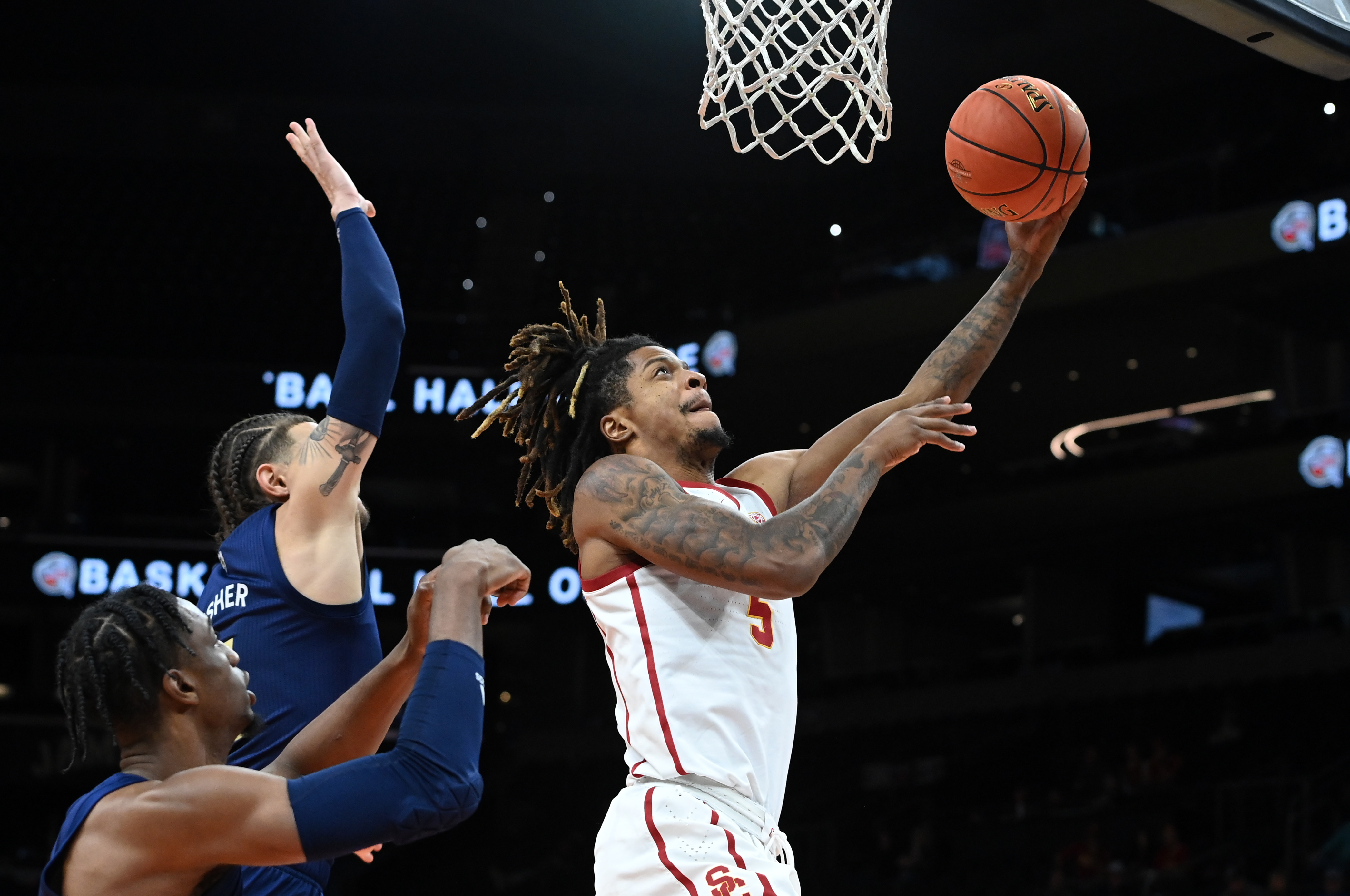 Isaiah White #5 of the University of Southern California Trojans scores on a lay up while being defended by Jordan Usher #4 of the Georgia Tech Yellow Jackets during the second half at the Jerry Colangelo Classic at Footprint Center on Dec. 18, 2021 in Phoenix. (Norm Hall/Getty Images)