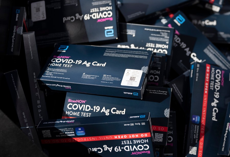 At-home rapid COVID-19 test kits are given away during a drive-thru event at the Hollywood library on Dec. 30, 2021 in Hollywood, Florida. (Joe Raedle/Getty Images)