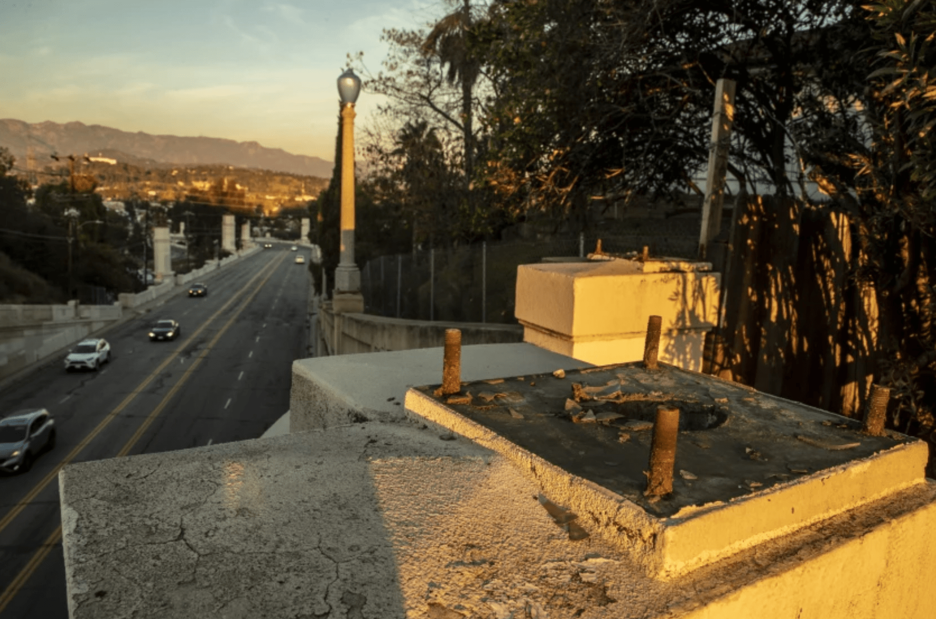 Large bolts remain where a bronze streetlight once stood on the Glendale-Hyperion Viaduct on Monday. Twenty-two lights have been stolen, and the L.A. Bureau of Street Lighting has removed an additional 18 lights for safeguarding.(Brian van der Brug / Los Angeles Times)