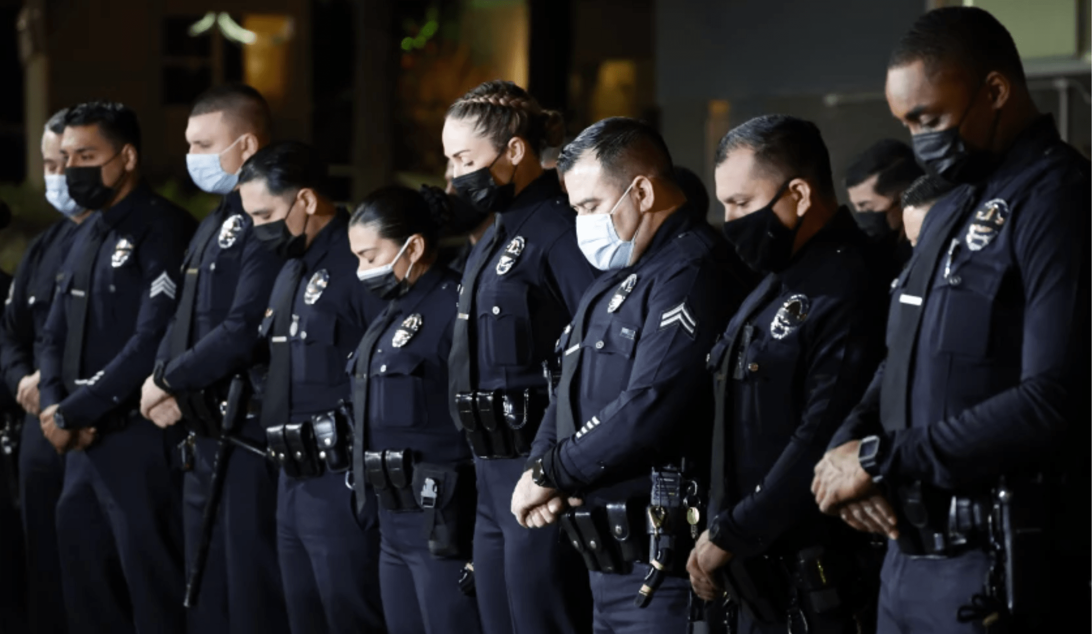 Los Angeles Police officers bow their heads in prayer to honor their fallen colleague, Officer Fernando Arroyos, who was shot and killed during an armed robbery.(Gina Ferazzi / Los Angeles Times)