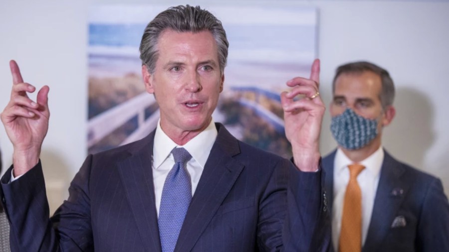 Los Angeles Mayor Eric Garcetti, right, listens as Gov. Gavin Newsom speaks during a Sept. 29 news conference in Los Angeles. Both Garcetti and Newsom are under fire after they were photographed without face masks at the NFC Championship game at SoFi Stadium.(Allen J. Schaben / Los Angeles Times)