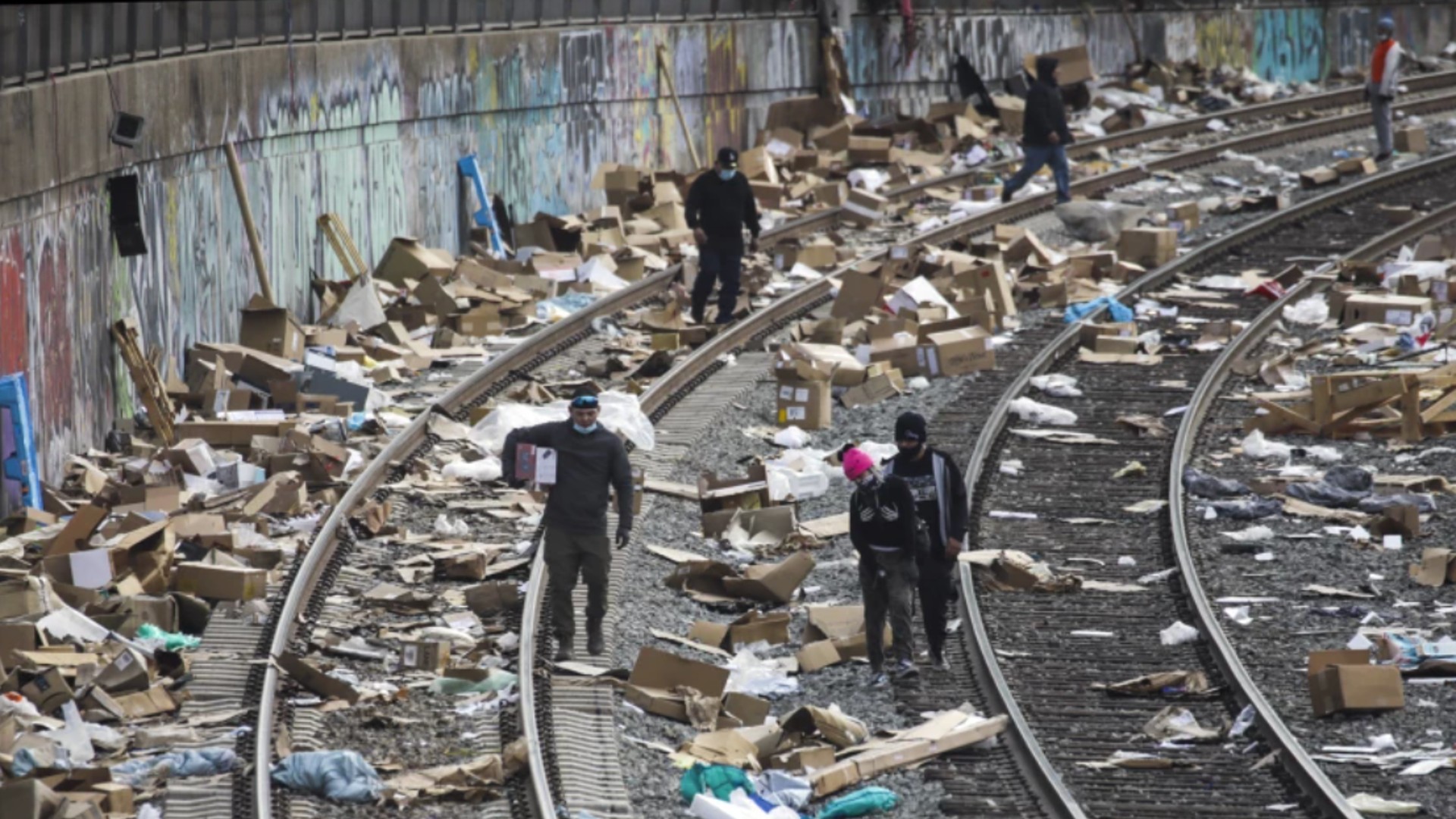 Packaging debris and items stolen from rail cars litter train tracks on Jan. 15, 2022, in Lincoln Heights, drawing scavengers.(Irfan Khan / Los Angeles Times)