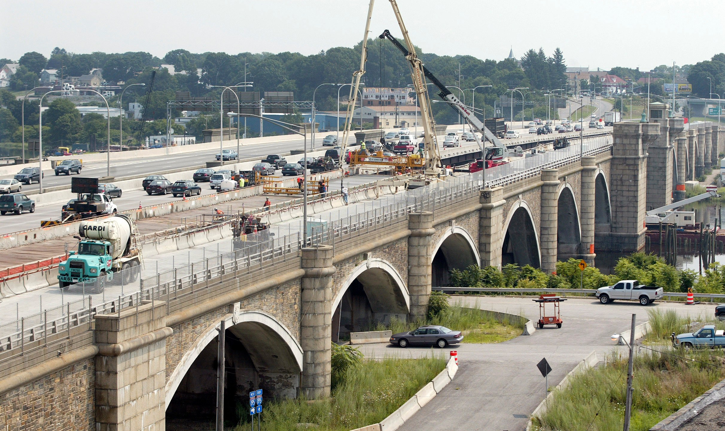 Construction workers pour concrete that will become part of the eastbound lanes of the Washington Bridge in Providence, R.I., on Aug. 4, 2007. The Washington Bridge, which spans the Seekonk River and connects Providence to East Providence, was completed in 1930 and is undergoing a complete replacement. (AP Photo/Stew Milne)