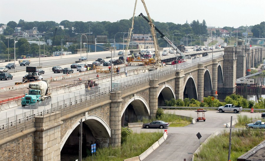 Construction workers pour concrete that will become part of the eastbound lanes of the Washington Bridge in Providence, R.I., on Aug. 4, 2007. The Washington Bridge, which spans the Seekonk River and connects Providence to East Providence, was completed in 1930 and is undergoing a complete replacement. (AP Photo/Stew Milne)