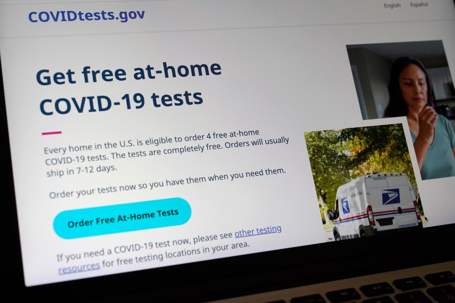 A United States government website is displayed on a computer, Wednesday, Jan. 19, 2022, in Walpole, Mass., that features a page where people can order free, at-home COVID-19 tests. The website, COVIDTests.gov, allows people to order four at-home tests per residence and have them delivered by mail. (AP Photo/Steven Senne)