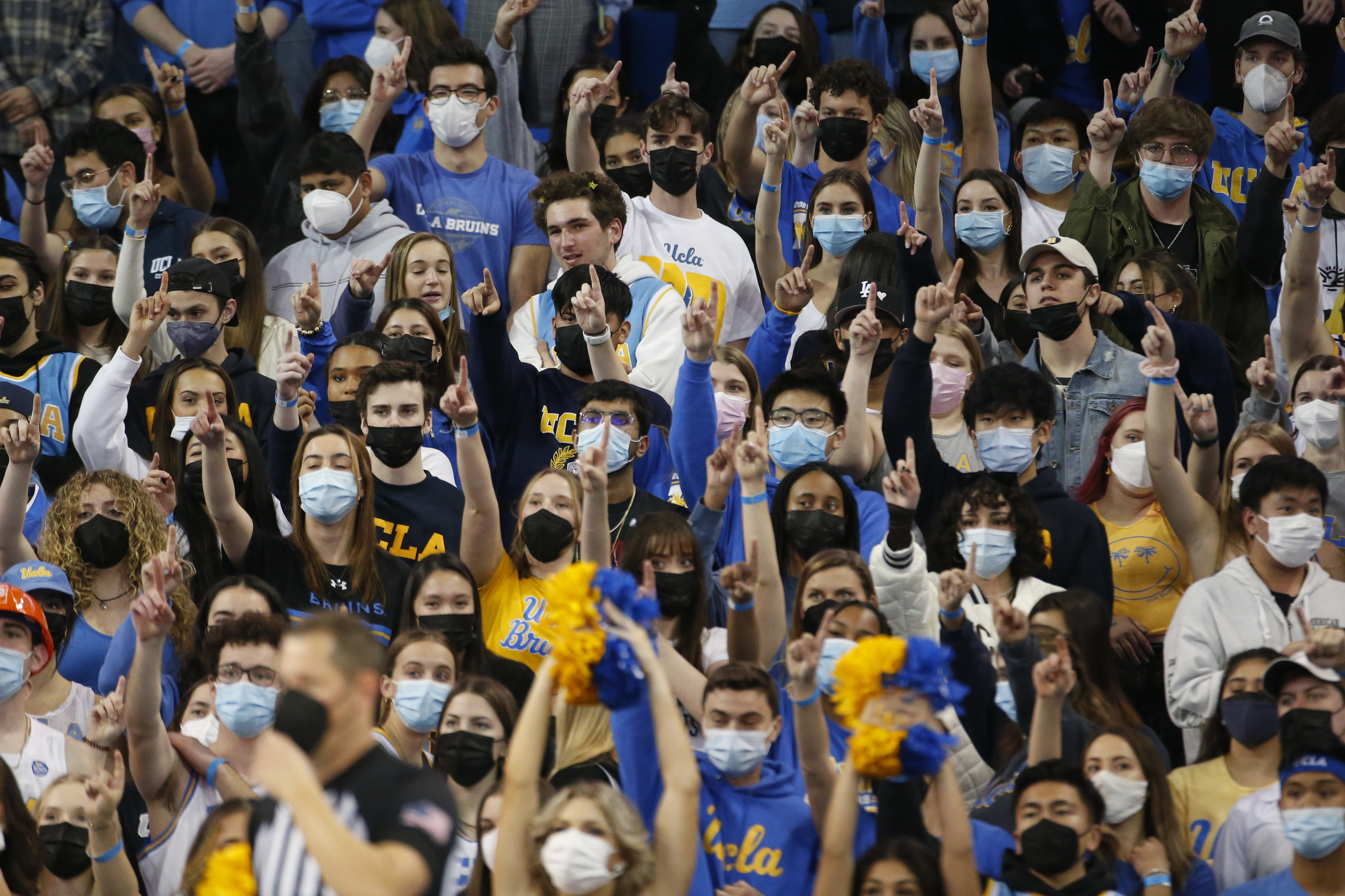 UCLA fans wearing face masks watch in the first half of an NCAA college basketball game against Stanford Saturday, Jan. 29, 2022, in Los Angeles. (AP Photo/Ringo H.W. Chiu)