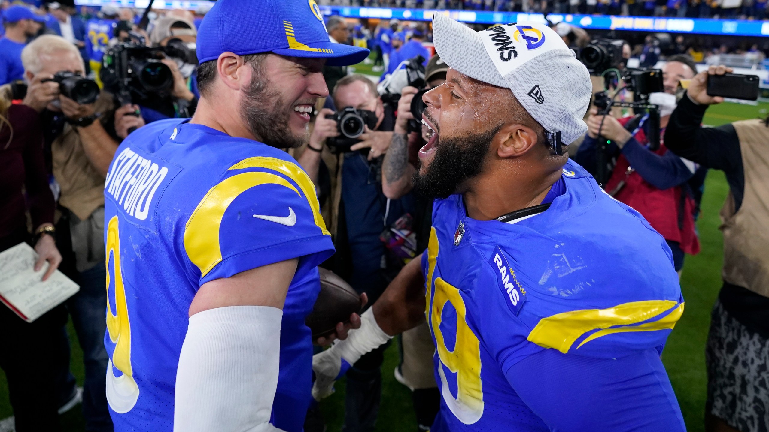 Los Angeles Rams' Matthew Stafford, left, and Aaron Donald celebrate after the NFC Championship NFL football game against the San Francisco 49ers Sunday, Jan. 30, 2022, in Inglewood, Calif. The Rams won 20-17 to advance to the Super Bowl. (AP Photo/Marcio Jose Sanchez)