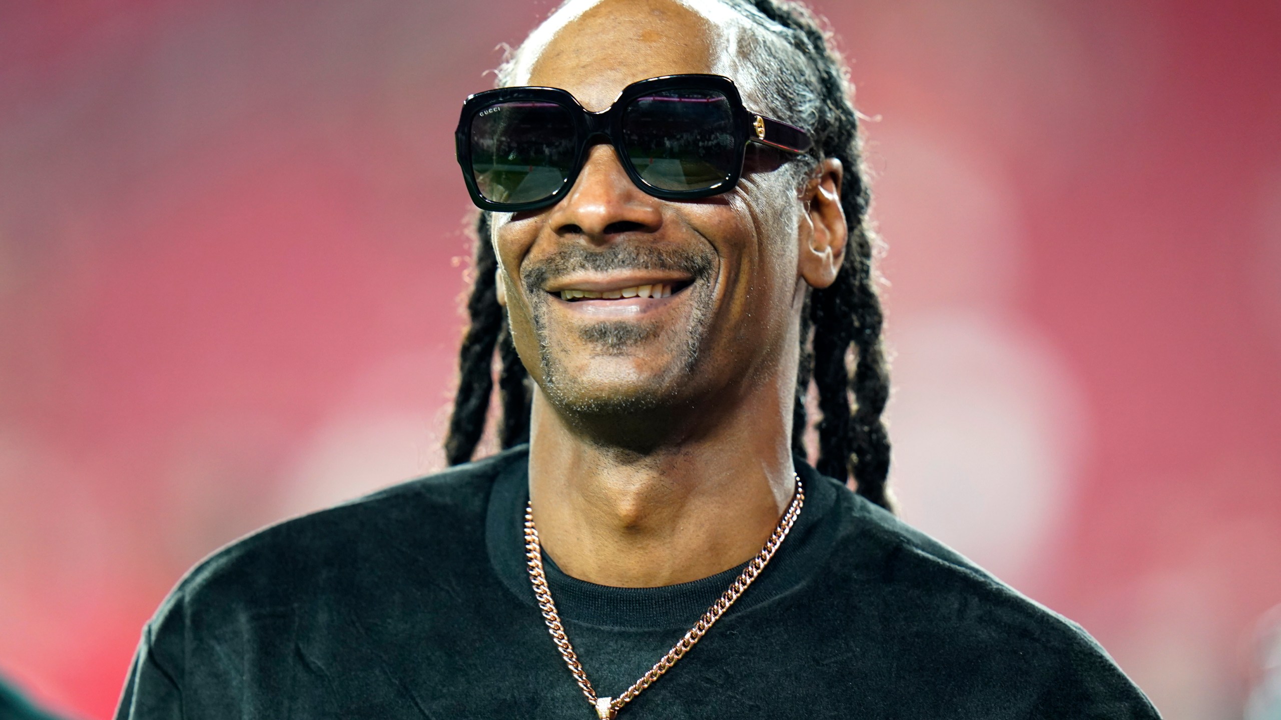 Entertainer Snoop Dogg walks on the field before an NFL football game between the Tampa Bay Buccaneers and the New Orleans Saints Sunday, Dec. 19, 2021, in Tampa, Fla. Snoop Dogg says he won’t let the big Super Bowl stage rattle his nerves. The ultra-smooth rapper said he will worry about his upcoming halftime performance after the fact. He’ll take the stage with Dr. Dre, Eminem, Kendrick Lamar and Mary J. Blige during Super Bowl 56 on Sunday, Feb. 13, 2022. (AP Photo/Chris O'Meara, File)