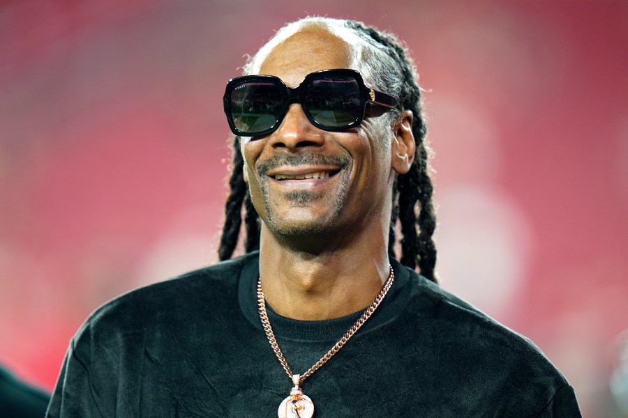 Entertainer Snoop Dogg walks on the field before an NFL football game between the Tampa Bay Buccaneers and the New Orleans Saints Sunday, Dec. 19, 2021, in Tampa, Fla. Snoop Dogg says he won’t let the big Super Bowl stage rattle his nerves. The ultra-smooth rapper said he will worry about his upcoming halftime performance after the fact. He’ll take the stage with Dr. Dre, Eminem, Kendrick Lamar and Mary J. Blige during Super Bowl 56 on Sunday, Feb. 13, 2022. (AP Photo/Chris O'Meara, File)