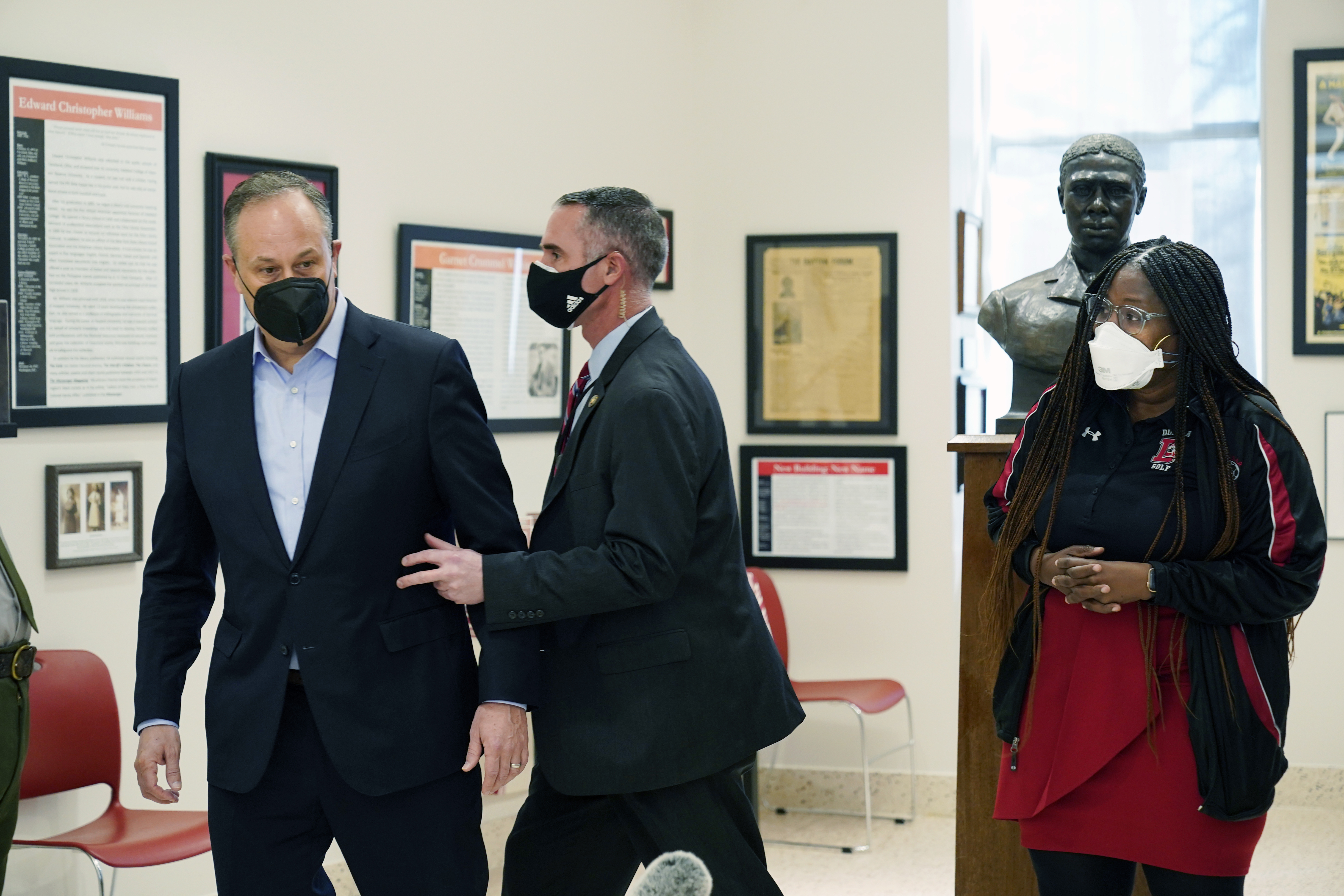 Doug Emhoff, the husband of Vice President Kamala Harris, is whisked out of an event at a high school by a Secret Service agent following an apparent security concern on Feb. 8, 2022 in Washington, D.C. (Manuel Balce Ceneta/Associated Press)