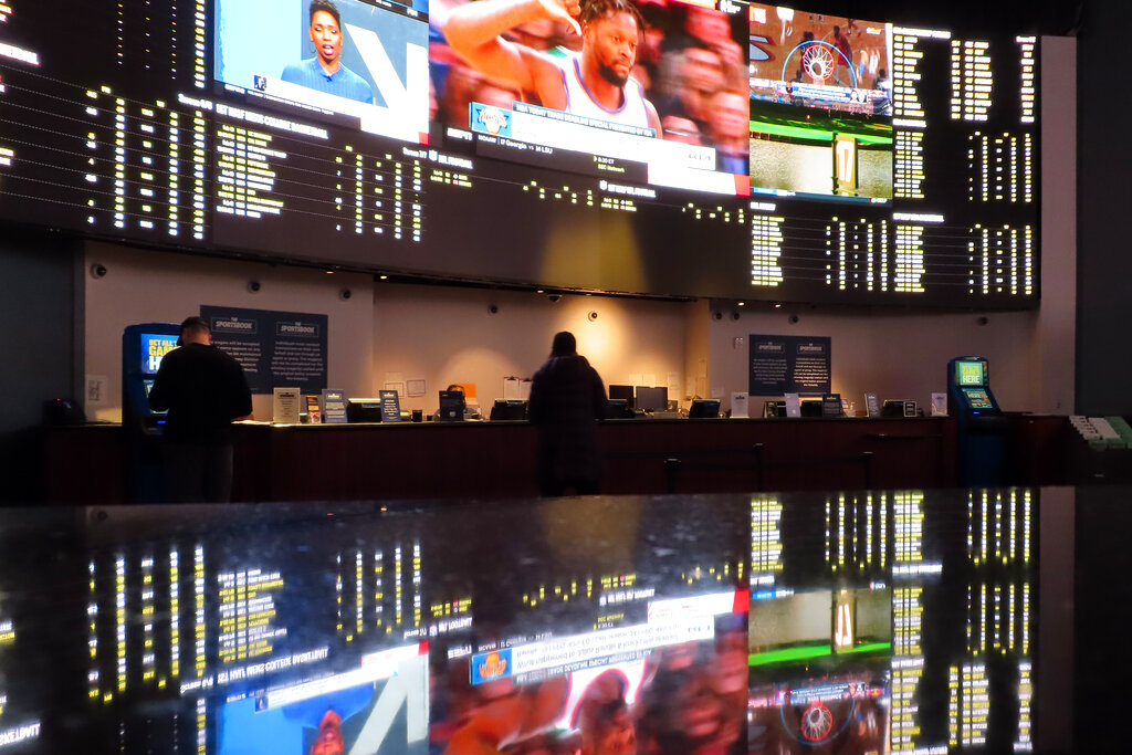 People make bets at the sportsbook at the Ocean Casino Resort, on Thursday, Feb. 10, 2022, in Atlantic City, N.J. (AP Photo/Wayne Parry)