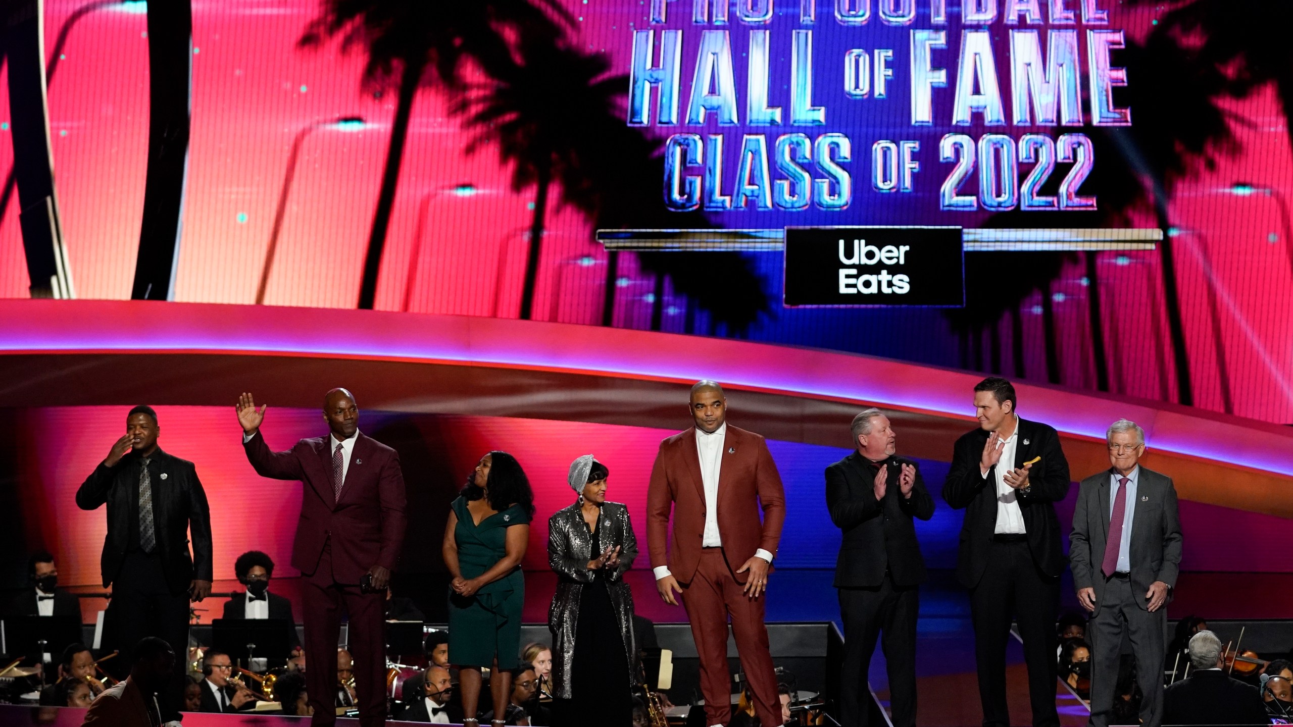 The 2022 NFL Football Hall of Fame class is seen during the NFL Honors show Thursday, Feb. 10, 2022, in Inglewood, Calif. The class is: Tony Boselli, LeRoy Butler, Sam Mills, Richard Seymour, Bryant Young, Cliff Branch, Art McNally and Dick Vermeil. Filling in for Sam Mills is Melanie Mills and filling in for Tony Boselli is Elain Anderson. (AP Photo/Mark J. Terrill)