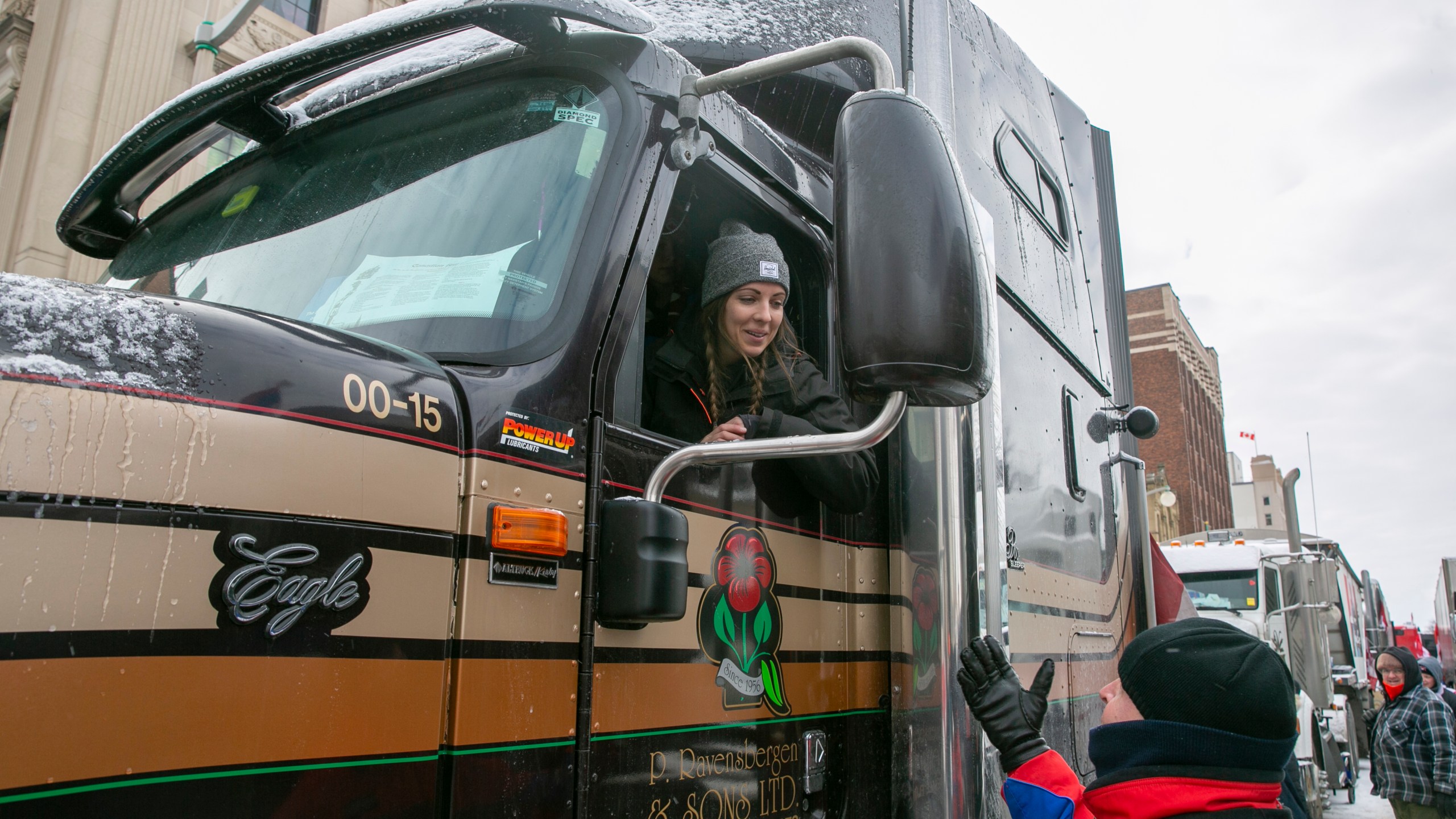 Stephanie Ravensbergen, 31, is in her family's truck in Ottawa, Ontario, on Saturday, Feb. 12, 2022. She came to support her aunt and uncle, who have parked their semi in the streets since the beginning of the COVID-19 restrictions mandate protest. She opposes vaccine and mask requirements and said it's important for schoolchildren to see their friends' faces and emotions. (AP Photo/Ted Shaffrey)