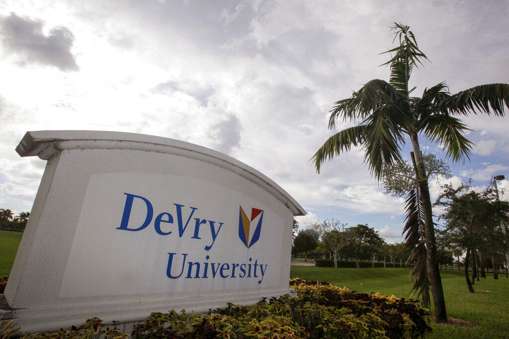 This Nov. 24, 2009, photo, shows the entrance to the DeVry University in Miramar, Fla. The Biden administration says it will cancel more than $70 million in student debt for borrowers who say they were defrauded by the for-profit DeVry University. It marks the first time the Education Department has approved such claims for an institution that's still in operation. (AP Photo/J Pat Carter, File)