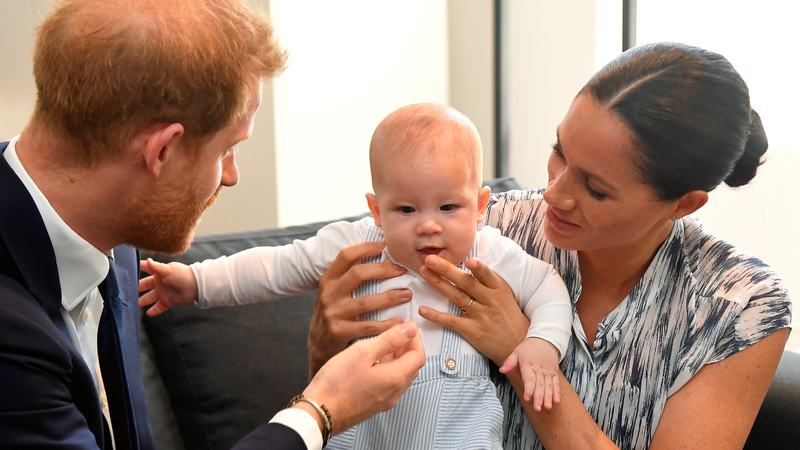 Prince Harry, Duke of Sussex and Meghan, Duchess of Sussex tend to their baby son Archie Mountbatten-Windsor at a meeting with Archbishop Desmond Tutu at the Desmond & Leah Tutu Legacy Foundation during their royal tour of South Africa on September 25, 2019 in Cape Town, South Africa. (Photo by Toby Melville - Pool/Getty Images)