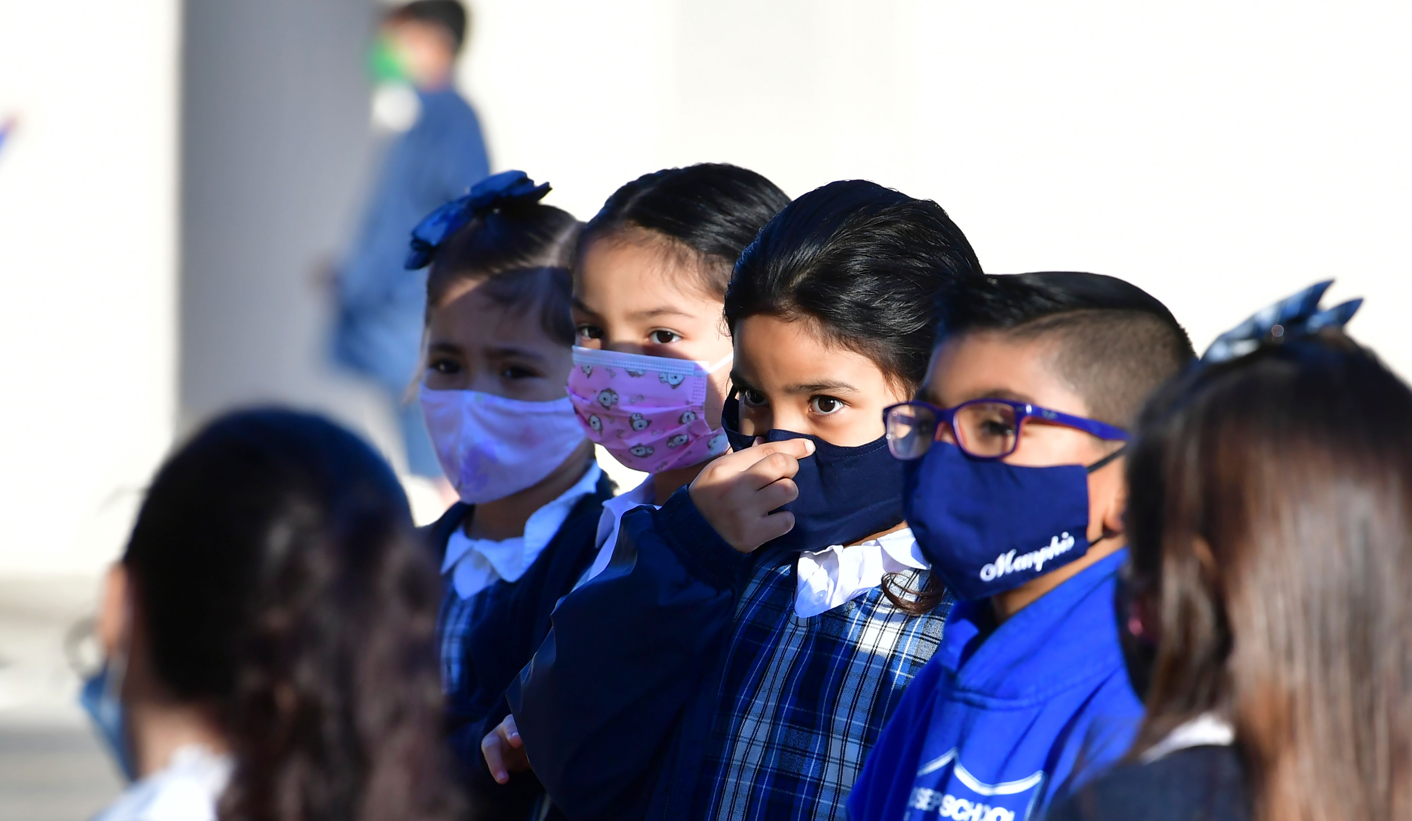 A student adjusts her face mask at St. Joseph Catholic School in La Puente on Nov. 16, 2020. (FREDERIC J. BROWN/AFP via Getty Images)