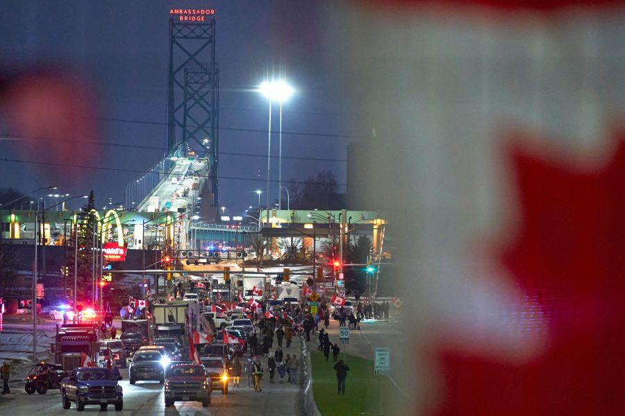 Demonstrators against Covid-19 vaccine mandates block the roadway at the Ambassador Bridge border crossing, in Windsor, Ontario, Canada on February 9, 2022. (Photo by GEOFF ROBINS/AFP via Getty Images)