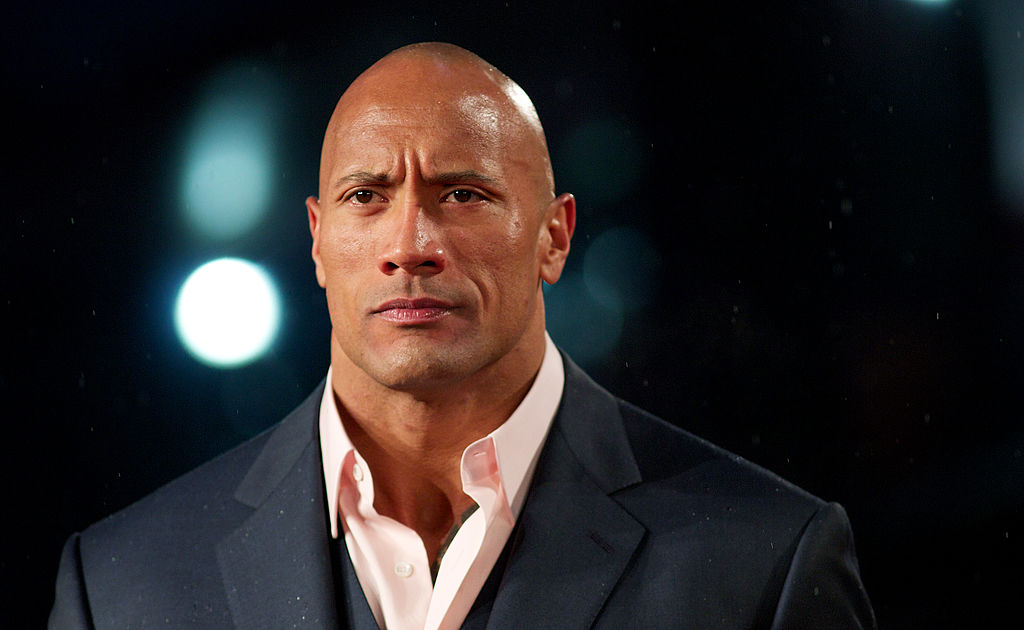 Actor Dwayne "The Rock" Johnson" poses for pictures on the red carpet as he arrives for the "G I Joe: Retaliation" UK film Premiere in central London on March 18, 2013. (ANDREW COWIE/AFP via Getty Images)