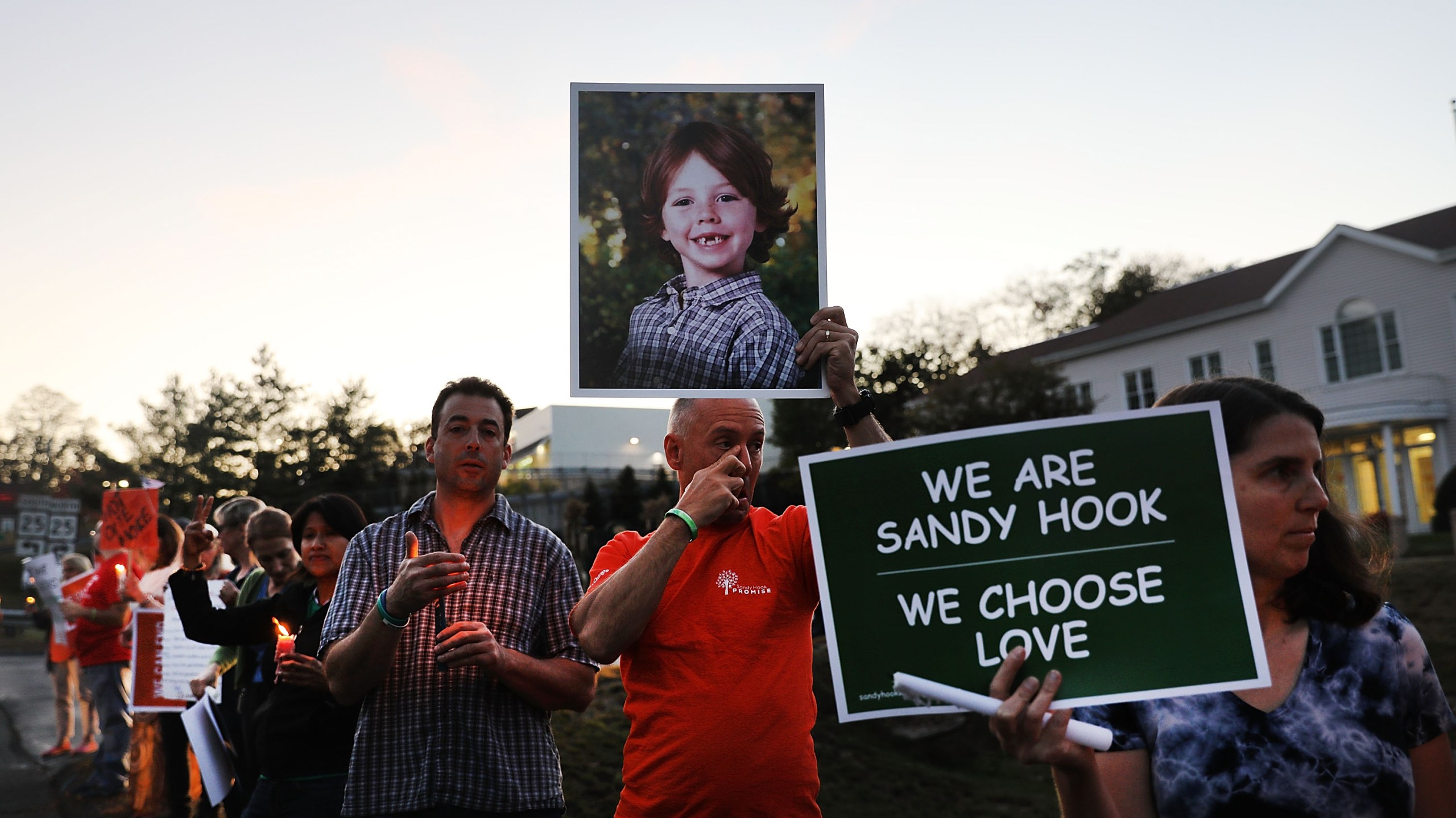 Mark Barden holds up a picture of his son Daniel who was killed in the Sandy Hook massacre during a vigil calling for action against guns on Oct. 4, 2017 in Newtown, Connecticut. (Spencer Platt/Getty Images)