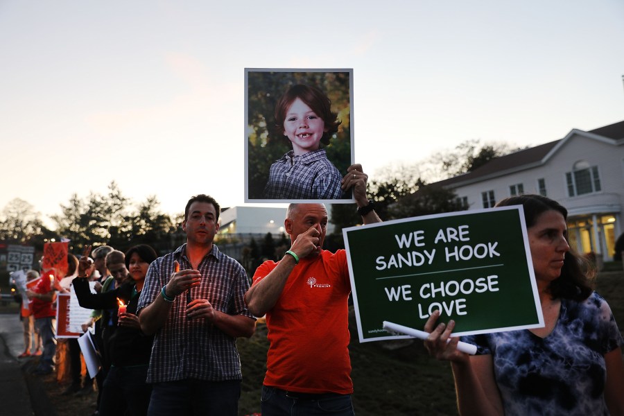 Mark Barden holds up a picture of his son Daniel who was killed in the Sandy Hook massacre during a vigil calling for action against guns on Oct. 4, 2017 in Newtown, Connecticut. (Spencer Platt/Getty Images)