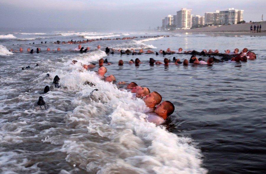 U.S. Navy SEAL candidates, participate in "surf immersion" during Basic Underwater Demolition/SEAL (BUD/S) training at the Naval Special Warfare (NSW) Center in Coronado, Calif., on May 4, 2020. A Navy SEAL candidate who died just hours after completing the grueling Hell Week test was identified Sunday, Feb. 6, 2022, as a 24-year-old sailor who joined the military last year. The U.S. Navy said that Seaman Kyle Mullen died at a San Diego area hospital on Friday, Feb. 4, after he and another SEAL trainee reported experiencing symptoms of an unknown illness. (MC1 Anthony Walker/U.S. Navy via AP, File)