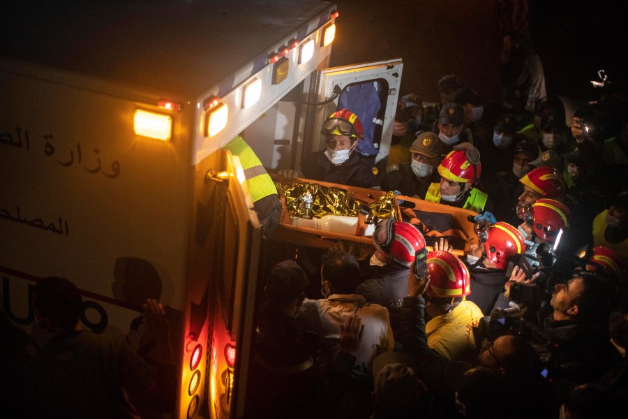 The body of 5-year-old Rayan, wrapped in foil, is retrieved after he fell into a hole and was stuck there for several days, in the village of Ighran in Morocco's Chefchaouen province, Saturday, Feb. 5, 2022. (AP Photo/Mosa'ab Elshamy)