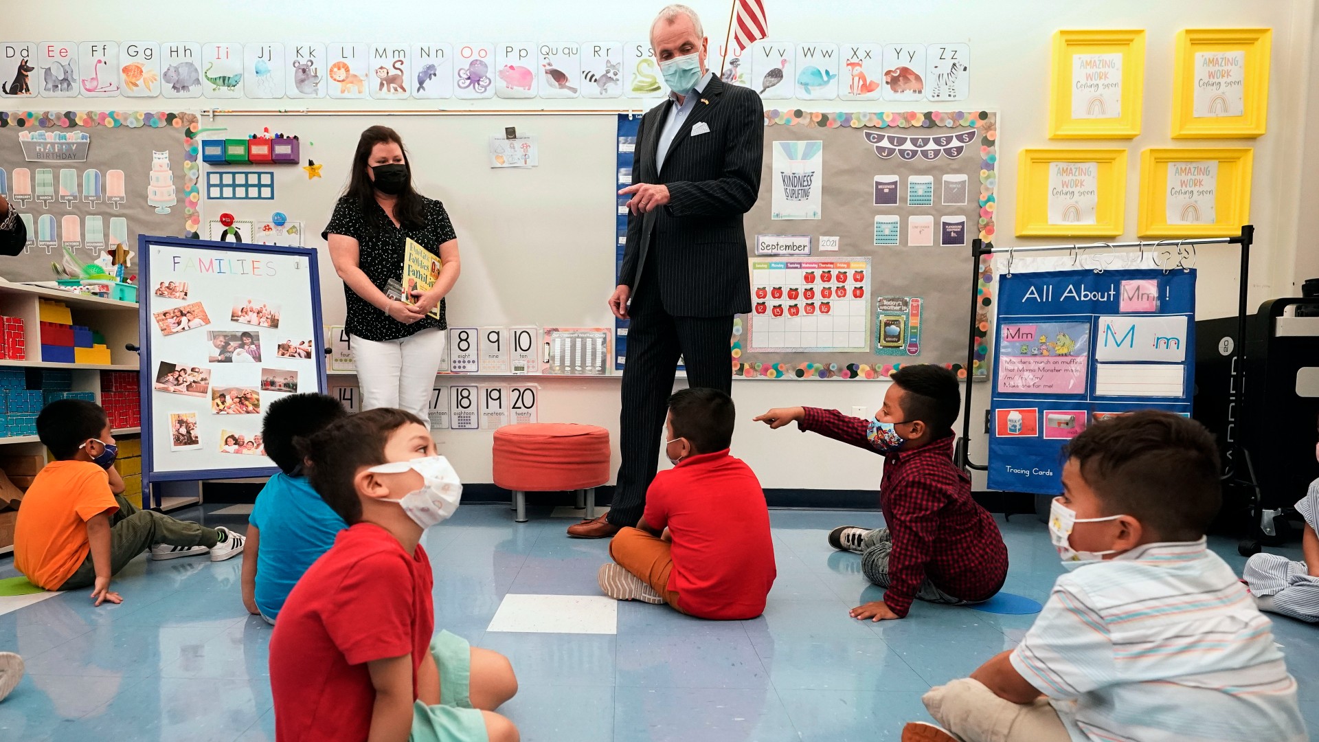 FILE — New Jersey Gov. Phil Murphy talks to three and four year old students in a pre-K class at the Dr. Charles Smith Early Childhood Center, Sept. 16, 2021, in Palisades Park, N.J. Murphy will end a statewide mask mandate to protect against COVID-19 in schools and child care centers, his office said Monday, Feb 7, 2022. (AP Photo/Mary Altaffer, File)