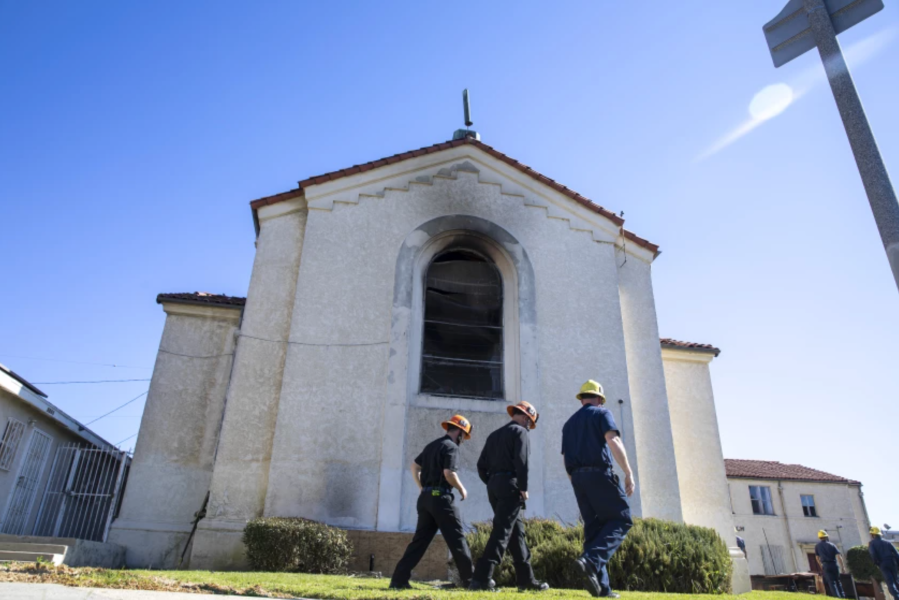 Los Angeles City firefighters look over the aftermath of a fire at St. Johns United Methodist Church Sunday, Feb. 6, 2022 in Los Angeles, CA. (Brian van der Brug/Los Angeles Times)