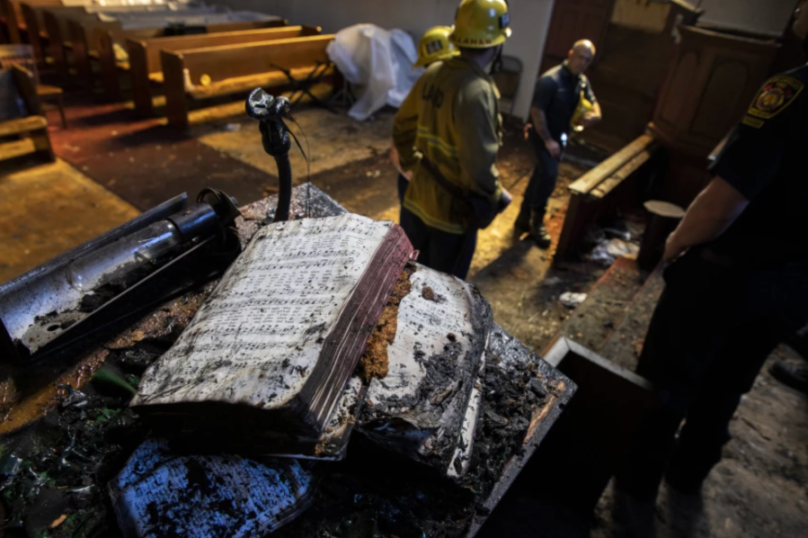 A singed hymnal on the pulpit in the aftermath of a fire at St. Johns United Methodist Church Sunday, Feb. 6, 2022 in Los Angeles, CA. (Brian van der Brug/Los Angeles Times)