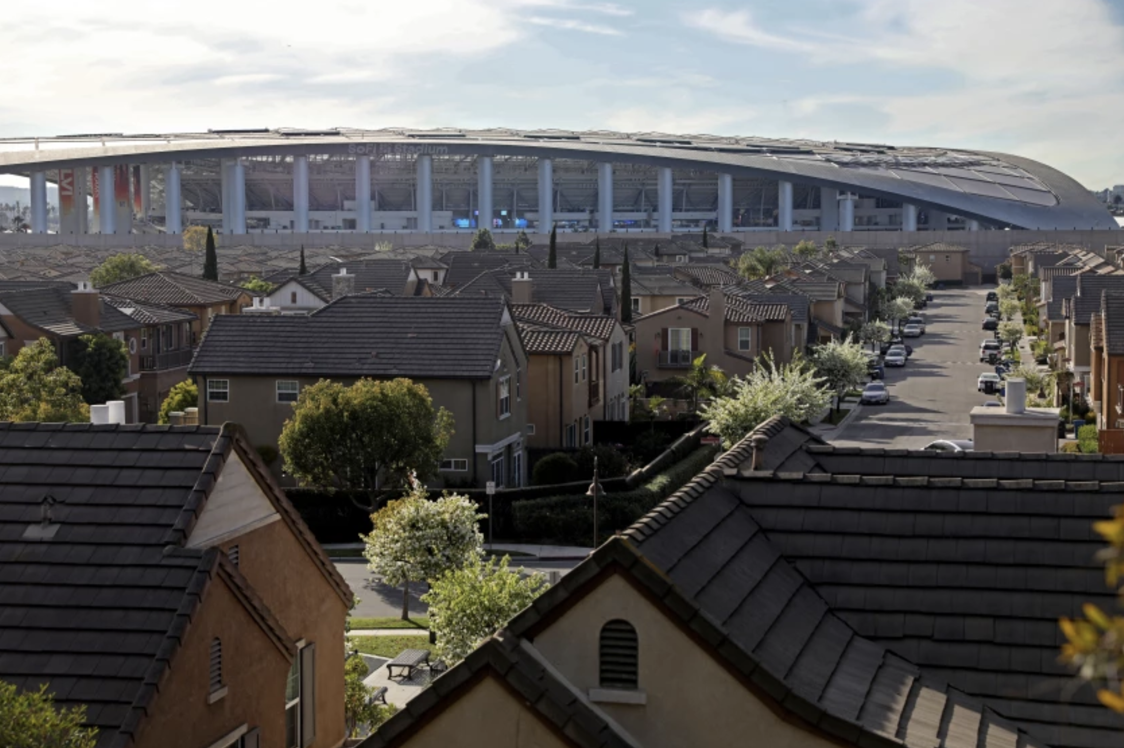 A housing community in Inglewood with SoFi Stadium in the background. The stadium and other development have driven up home prices in the city. (Gary Coronado / Los Angeles Times)