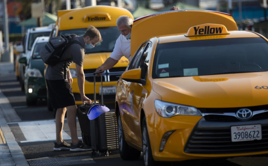 Taxis at LAX in 2020. Under a new L.A. ordinance, taxis will no longer have to be painted bright yellow or other colors and won’t be required to be plastered with signage. Instead, the vehicles will bear a decal.(Francine Orr / Los Angeles Times)