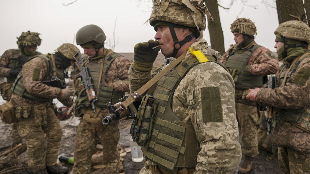 Ukrainian servicemen check their equipment during an exercise in a Joint Forces Operation controlled area in the Donetsk region, eastern Ukraine, Thursday, Feb. 10, 2022. A separate group of border guards at a Ukrainian island in the Black Sea were killed on Thursday after telling a Russian warship to "go f--- yourself." (AP Photo/Vadim Ghirda)