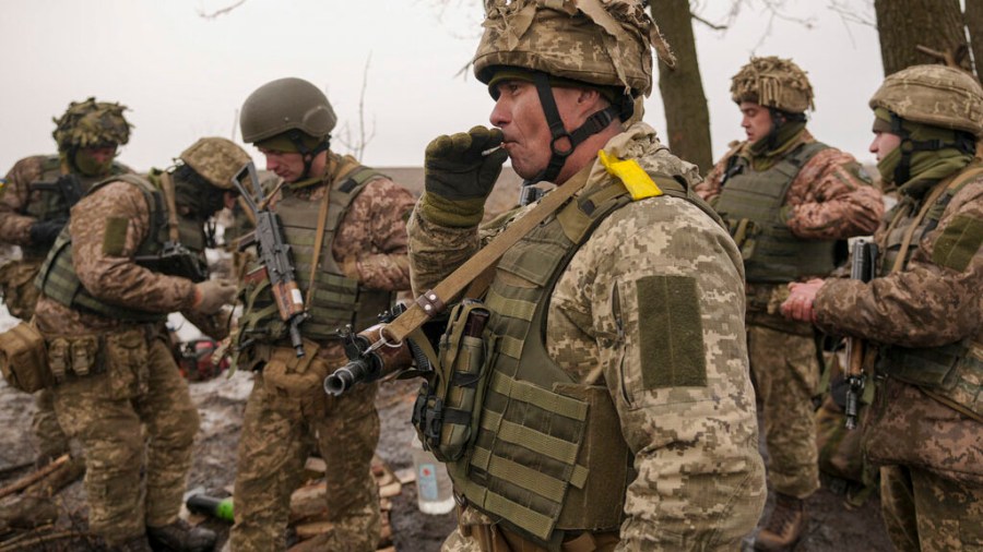 Ukrainian servicemen check their equipment during an exercise in a Joint Forces Operation controlled area in the Donetsk region, eastern Ukraine, Thursday, Feb. 10, 2022. A separate group of border guards at a Ukrainian island in the Black Sea were killed on Thursday after telling a Russian warship to "go f--- yourself." (AP Photo/Vadim Ghirda)