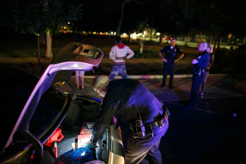 An officer from the LAPD’s Metropolitan Division check a vehicle in November 2015. (Marcus Yam / Los Angeles Times)