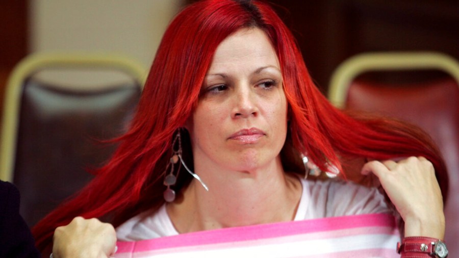 In this Dec. 13, 2004, file photo, Juror number 7, Richelle Nice, adjusts her hair as members of the jury speak with the media in the Old San Mateo County Courthouse in Redwood City. (Lou Dematteis/Associated Press)