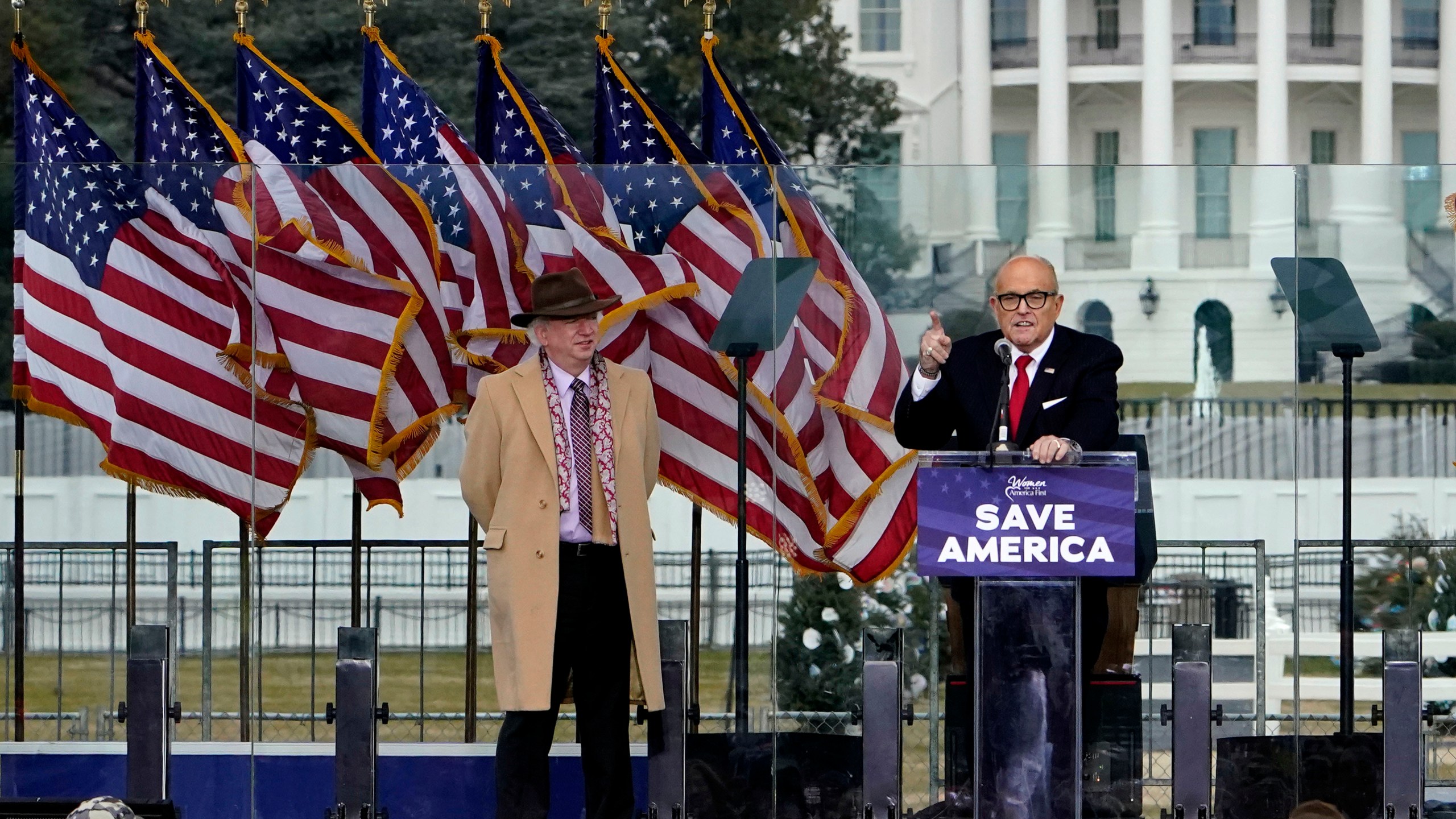 Chapman University law professor John Eastman stands at left as former New York Mayor Rudolph Giuliani speaks in Washington at a rally in support of President Donald Trump, called the "Save America Rally" on Jan. 6, 2021. (Jacquelyn Martin/Associated Press)