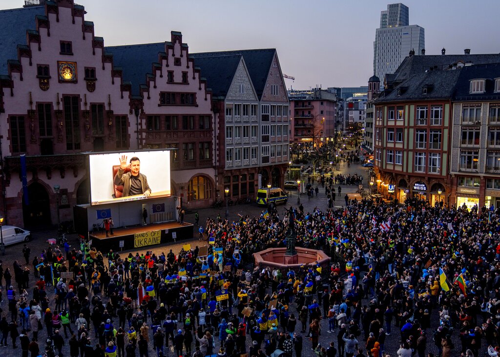 Ukrainian President Volodymyr Zelenskyy delivers a video message to the people joining a rally on the Remember square in Frankfurt, Germany, Friday, March 4, 2022. (AP Photo/Michael Probst)