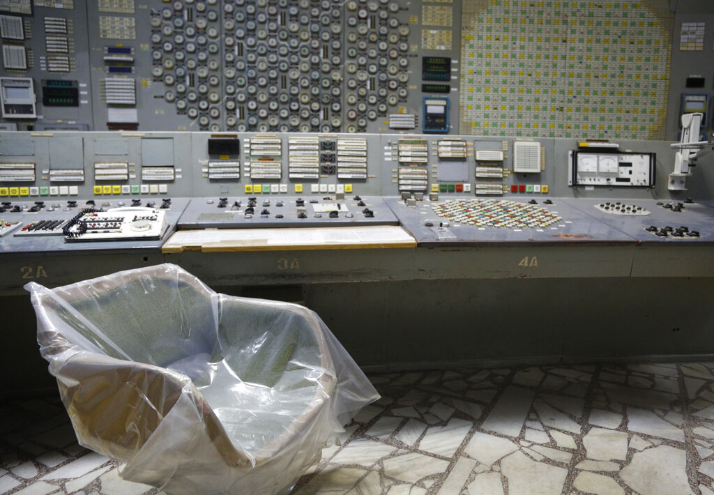 An operator's arm-chair covered with plastic sits in an empty control room of the 3rd reactor at the Chernobyl nuclear plant, in Chernobyl, Ukraine, on April 20, 2018. Russia’s attack on a nuclear power plant in Ukraine has revived the fears of people across Europe who remember the 1986 Chernobyl disaster. (AP Photo/Efrem Lukatsky, File)