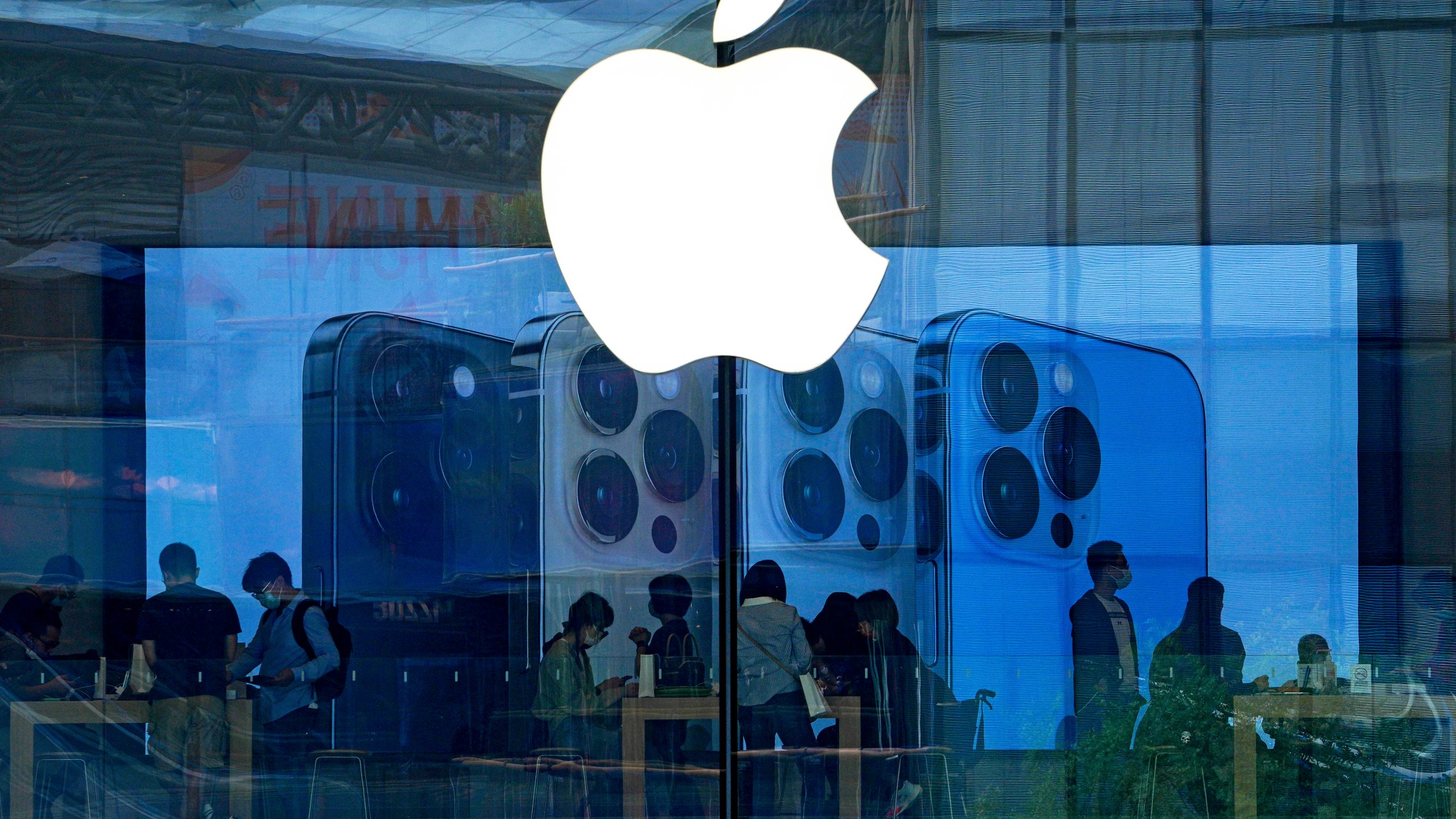 People shop at an Apple Store in Beijing, on Sept. 28, 2021. (AP Photo/Andy Wong, File)