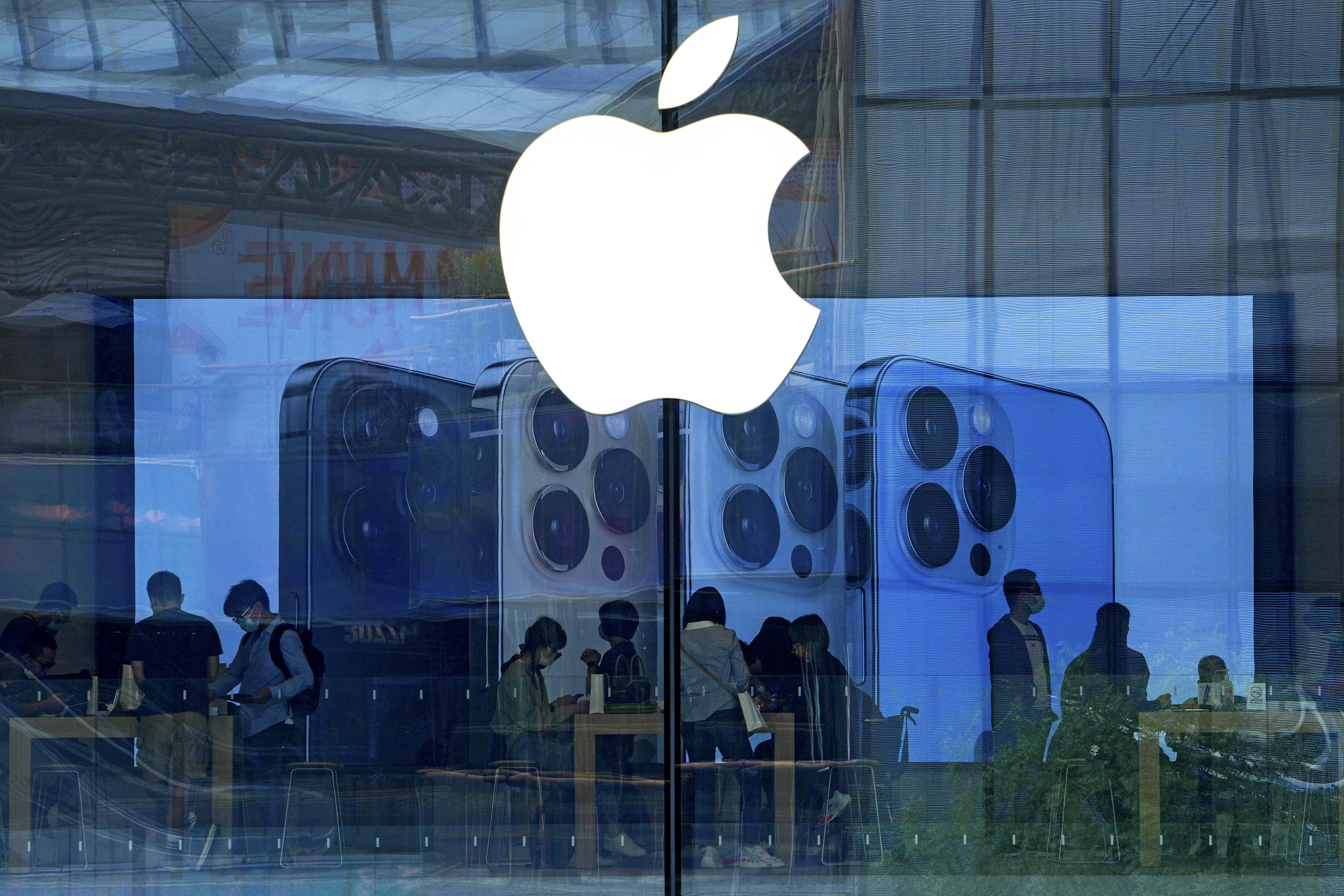 People shop at an Apple Store in Beijing, on Sept. 28, 2021. (AP Photo/Andy Wong, File)