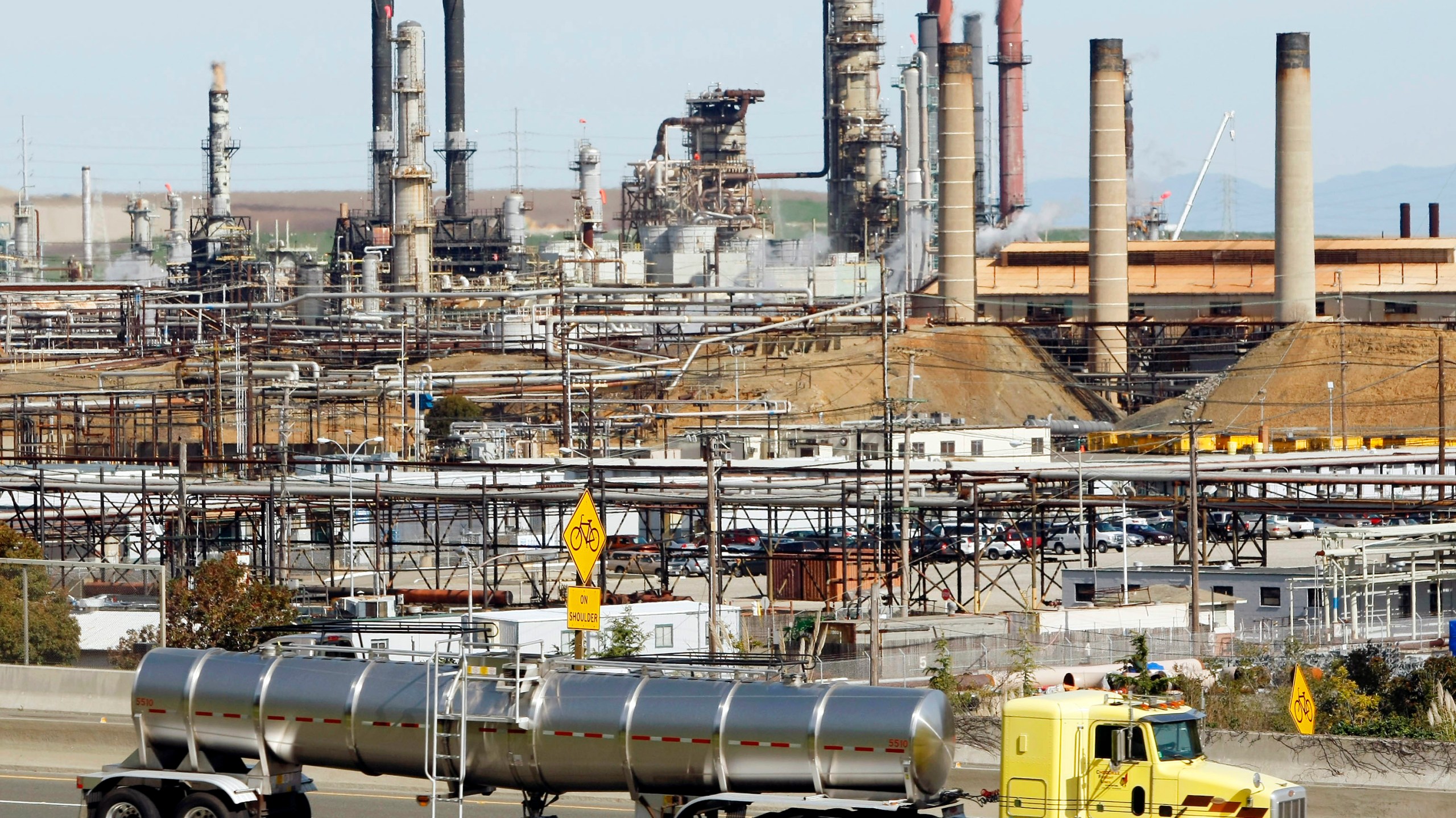 A tanker truck passes the Chevron oil refinery in Richmond, Calif., on March 9, 2010. More than 500 workers at the Chevron Corp. refinery in the San Francisco Bay area have told the company they will go on strike at 12:01 a.m. Monday, March 21, 2022. The United Steelworkers union says Sunday, March 20 that members of Local 5 voted down Chevron's most recent contract offer and gave notice of intent to go on strike. (AP Photo/Paul Sakuma, File)